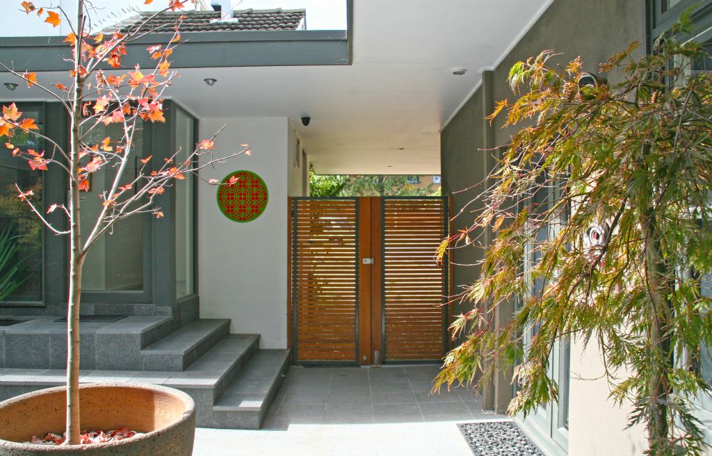 This project is an alteration and addition to an  Ainslie duplex that had previously been extended.  The work involved:- creating a modern kitchen and laundry, - converting the garage into a liveable space,- creating a transparent link to an earlier addition  at the back of the block, and- upgrading the central courtyard as the main private  outdoor space of the house.Key elements to the re-design of the courtyard are the  surrounding eaves that unify the space and the addition of a water feature as  its focus.  This water feature also acts  as a stair and seating bench and is integrated with the sliding glass doors of  the kitchen.  When the sliding doors are  open, the cool moist breeze and the sound of running water heighten the connection  between the kitchen and courtyard.</p